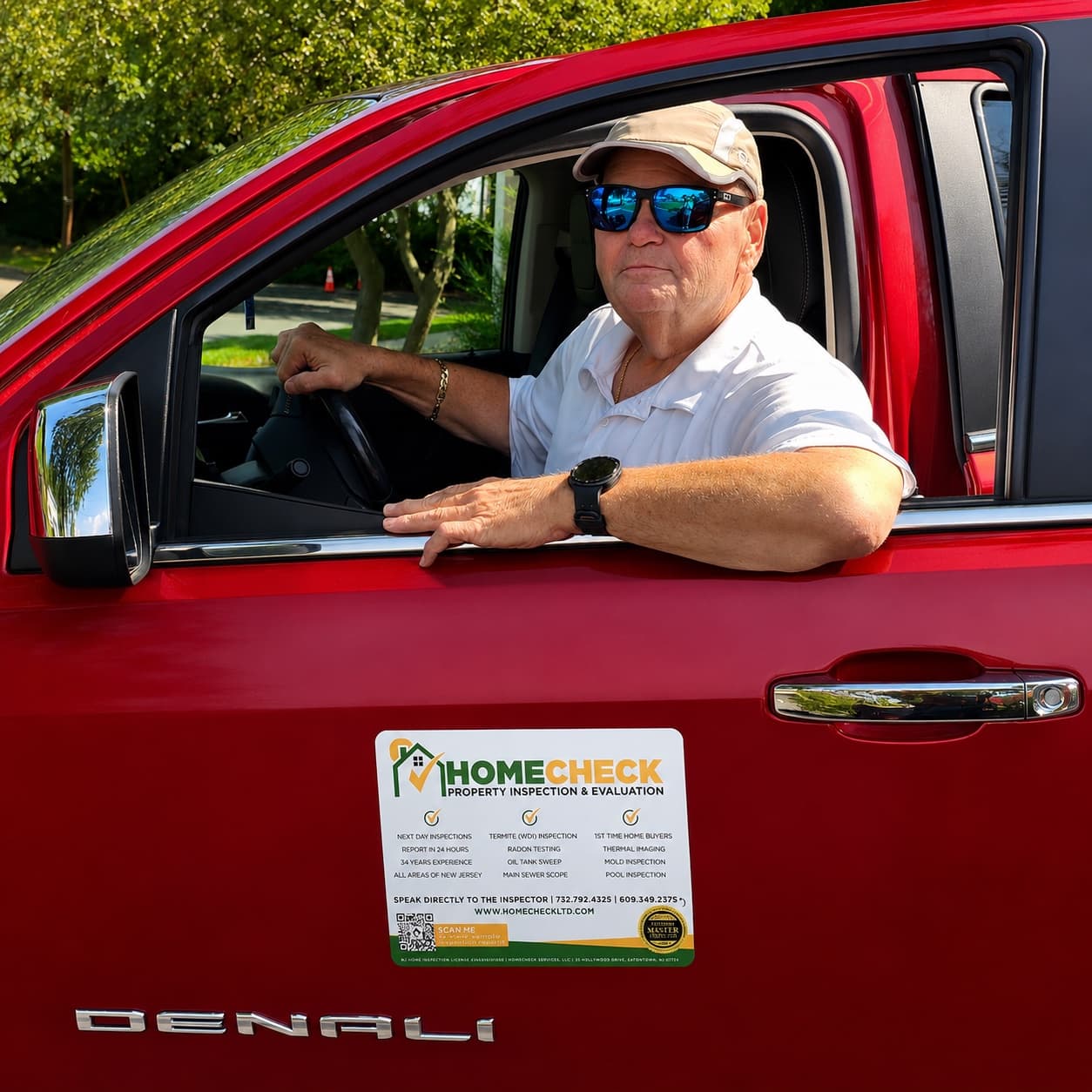 Jack Donlon in the driver's seat of his red HomeCheck truck, arm on the open window, with the HomeCheck door magnet below